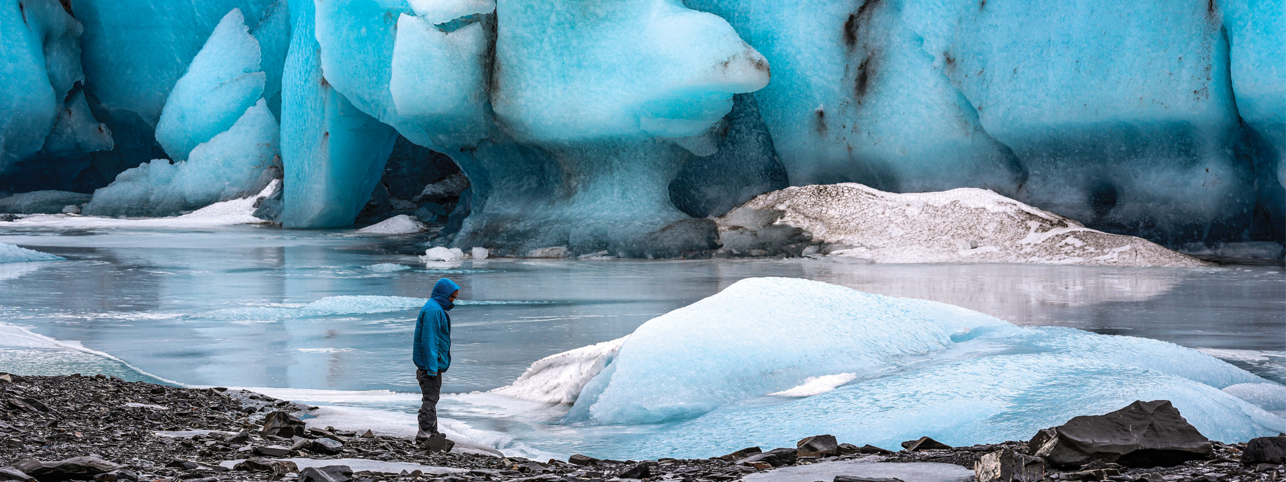 Man standing near glacier in Alaska
